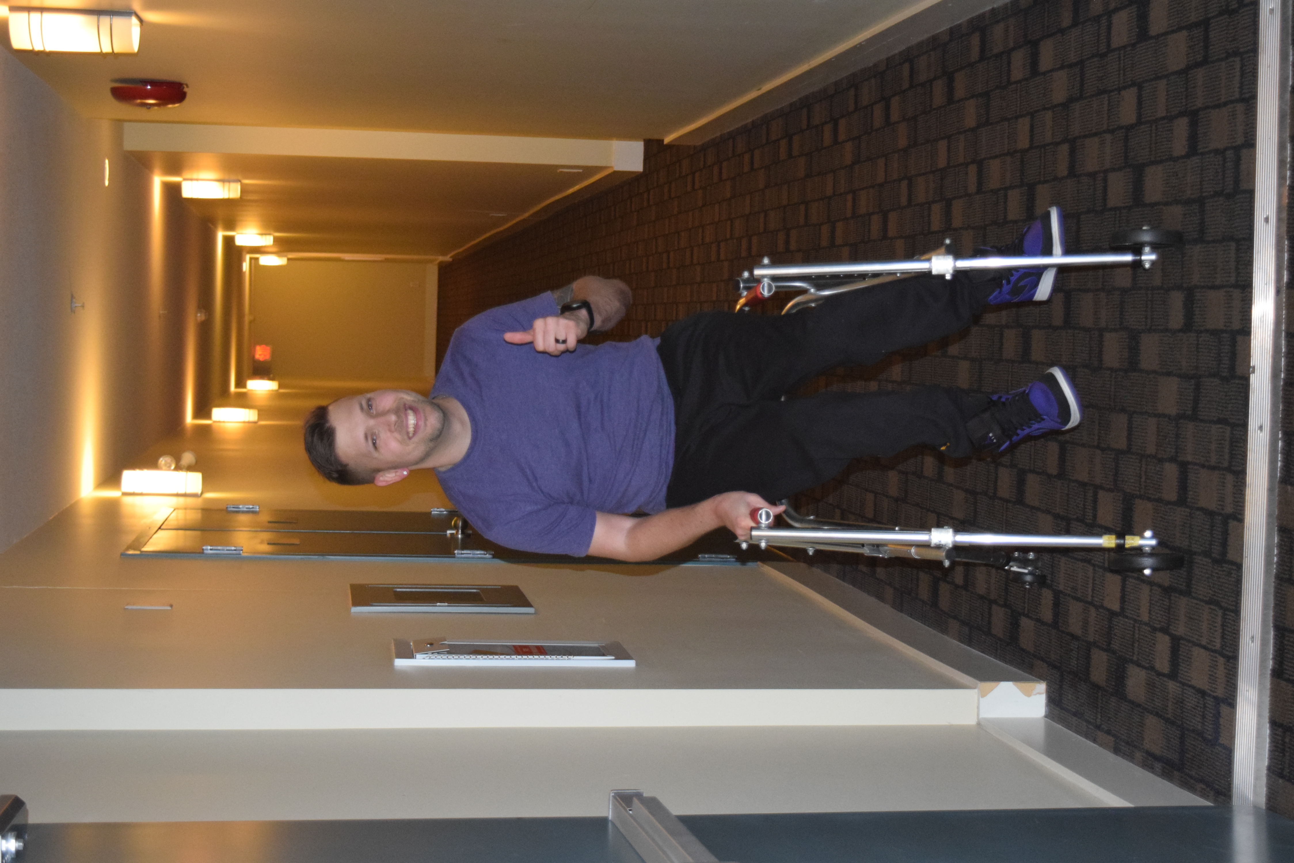 Marco using walker in condo hallway