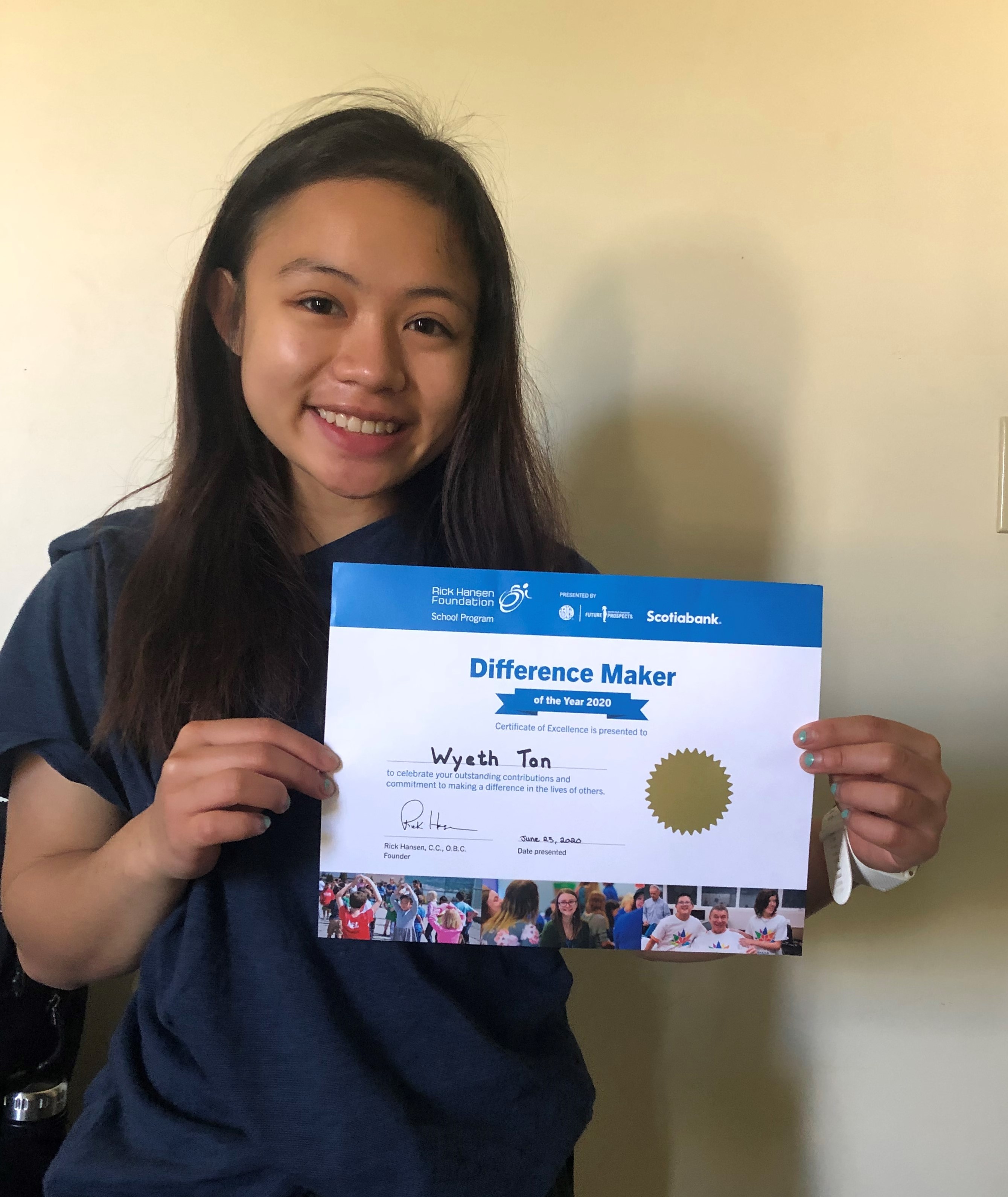 Wyeth holding her certificate, smiling