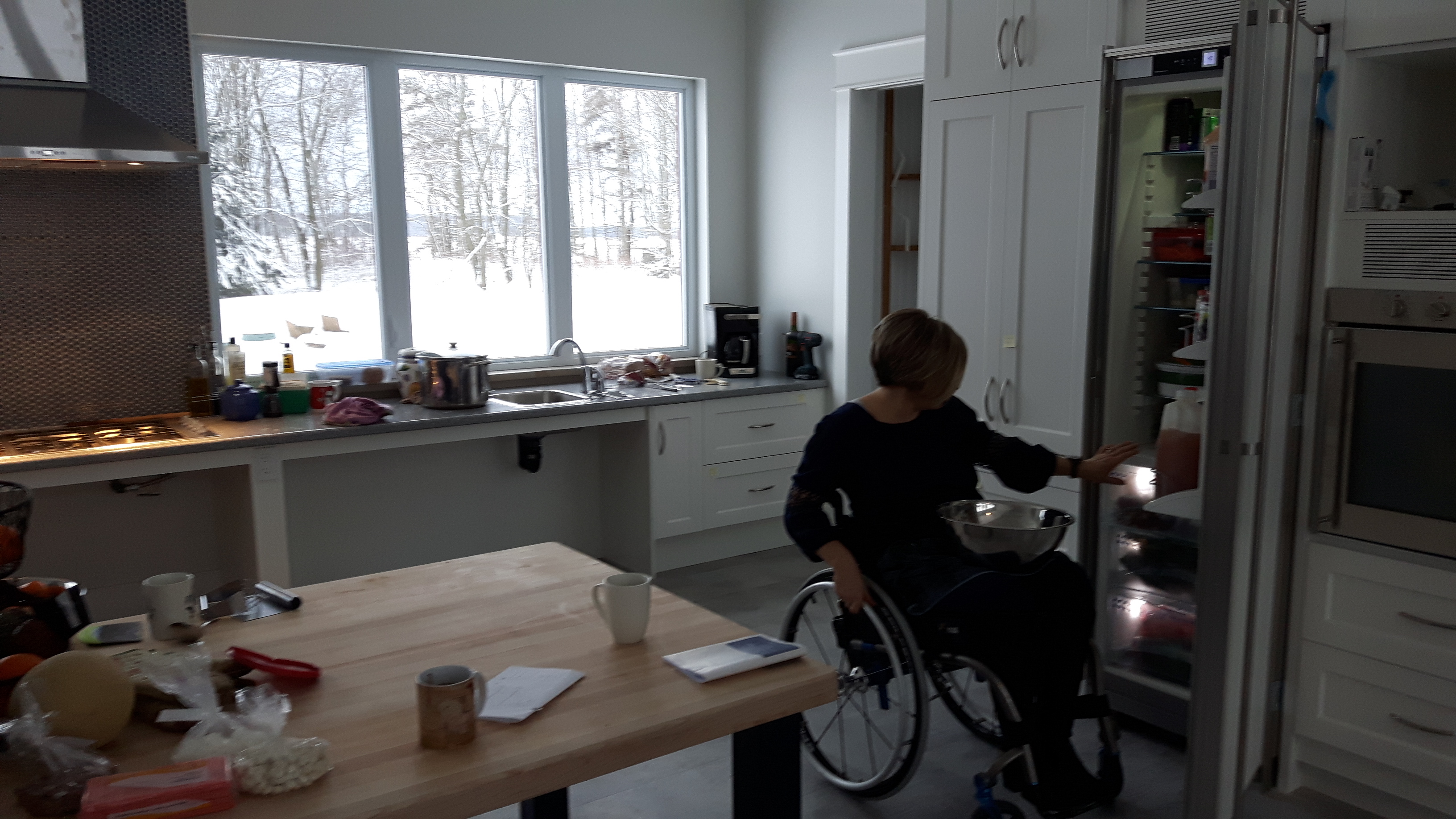 Julie uses her recently completed fully accessible kitchen in her wheelchair