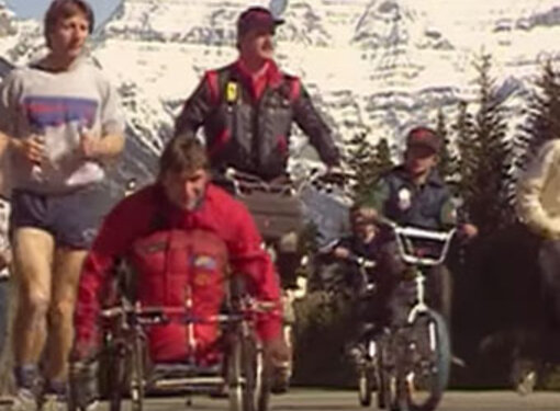 Rick Hansen wheels along the highway during the Man in Motion World Tour