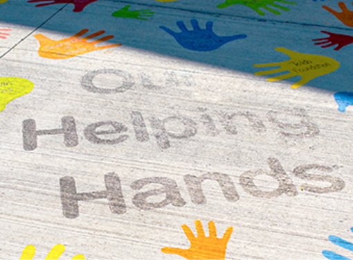 Our helping hands pavement art at accessible playground