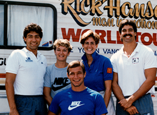Rick Hansen and his team standing in front of their motor home during the Man in Motion World Toura