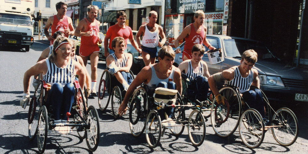 Rick Hansen in Adelaide, Australia accompanied by several other people in wheelchairs.