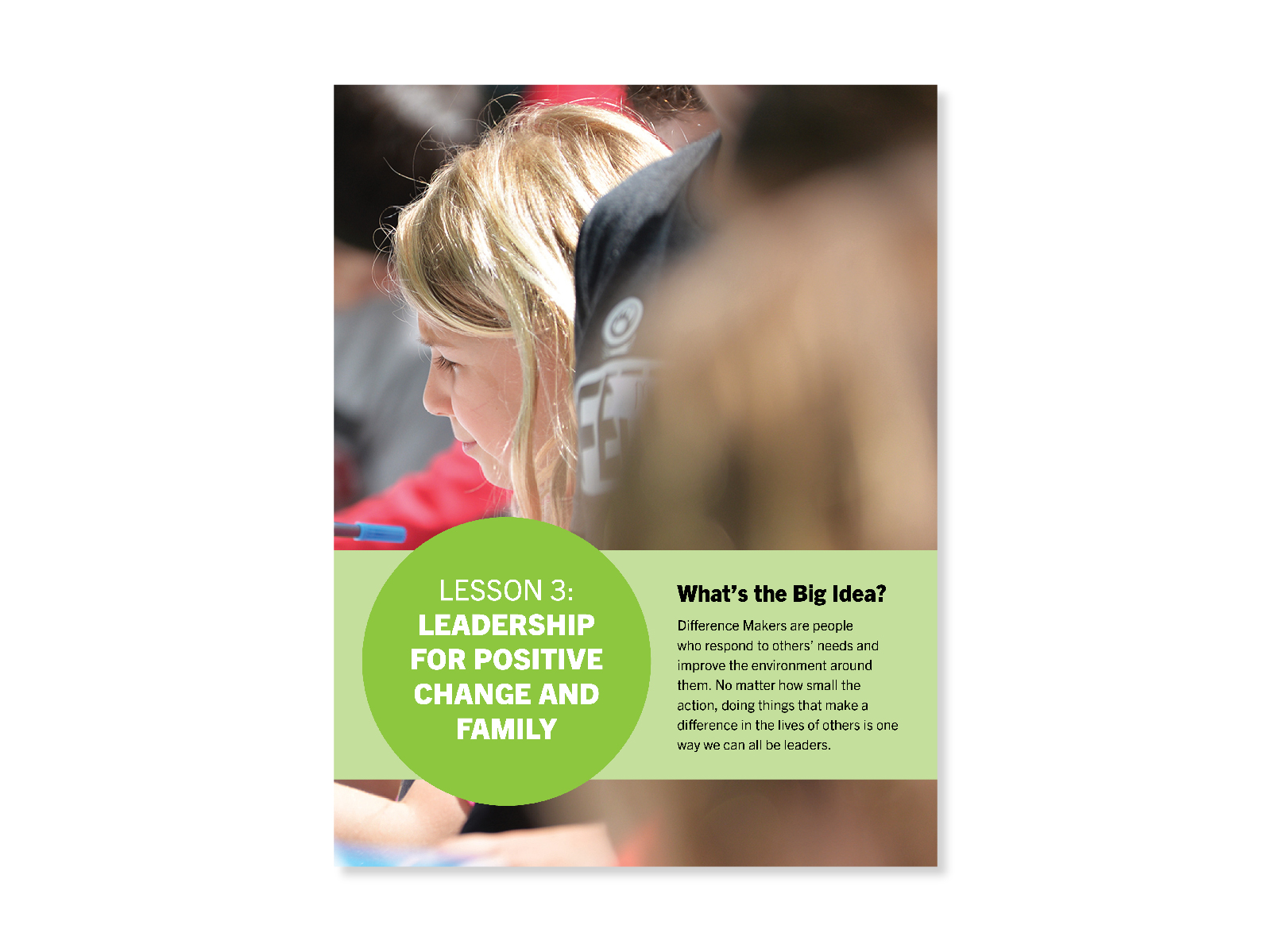 Photo of a group of students with the camera focused on an elementary aged girl with blonde hair looking off camera and working intently. Cover for "Leadership for Positive Change" lesson.