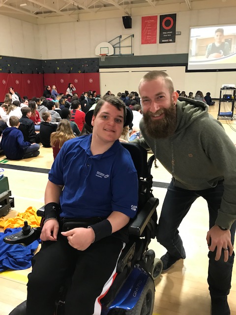 Tyler at Inclusivity Day with a student using a wheelchair