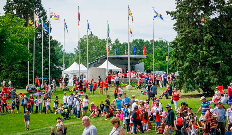 Crowd of people celebrating Canada Day at the park. 