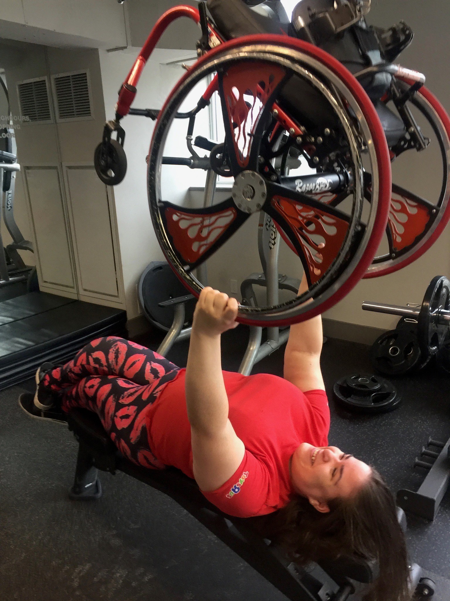 Jenna uses her wheelchair as a weight during a workout 