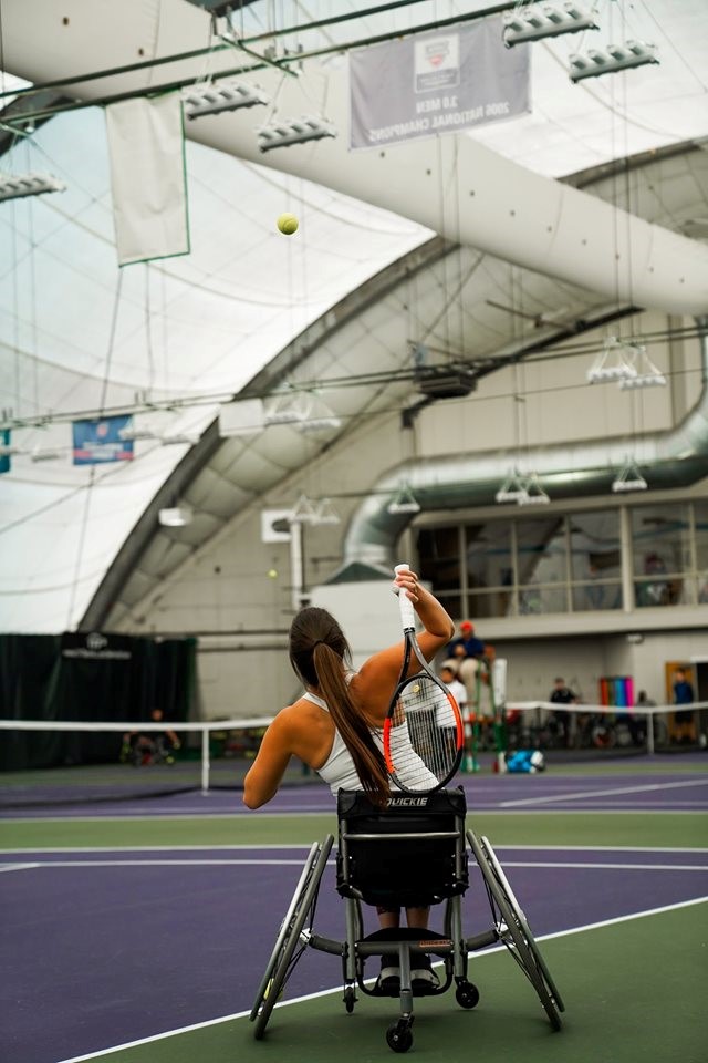 Anne-Marie playing wheelchair tennis.