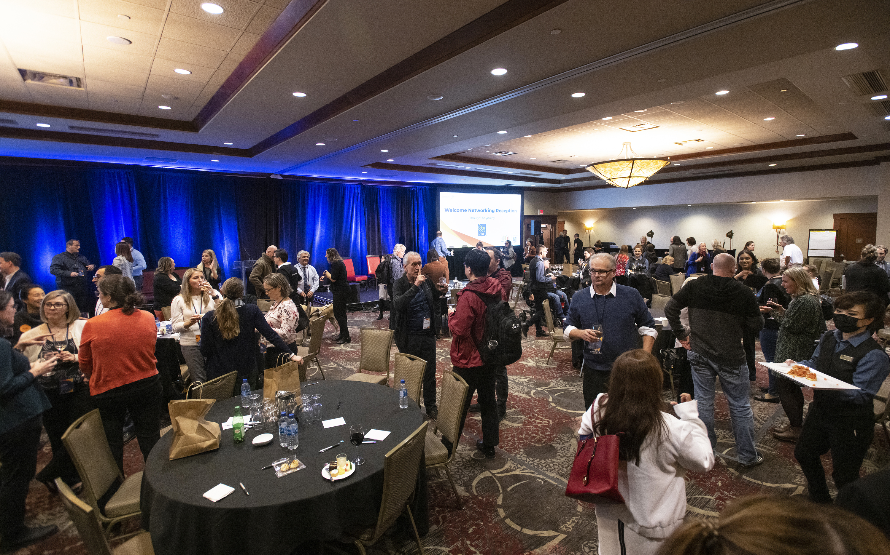 A large conference space filled with people of different abilities.