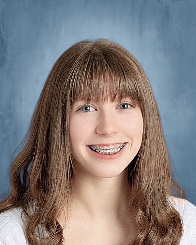 girl with brown hair, smiling