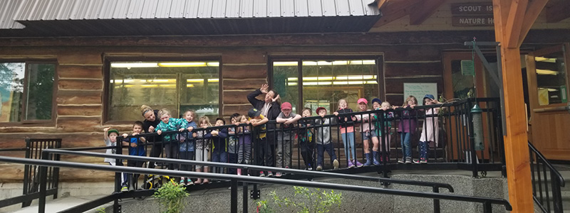 Group of students with teacher in the middle standing on an accessible ramp.