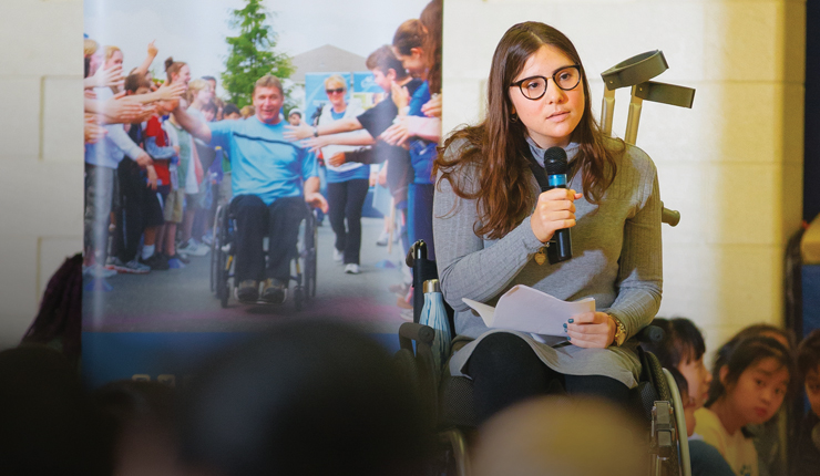 ambassador using wheelchair speaks to students
