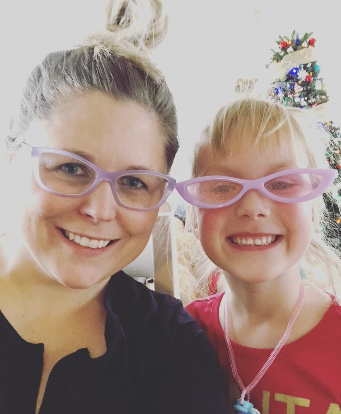 woman and young girl, smiling and wearing matching glasses