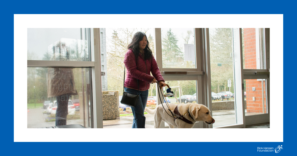 Woman with guide dog enters building