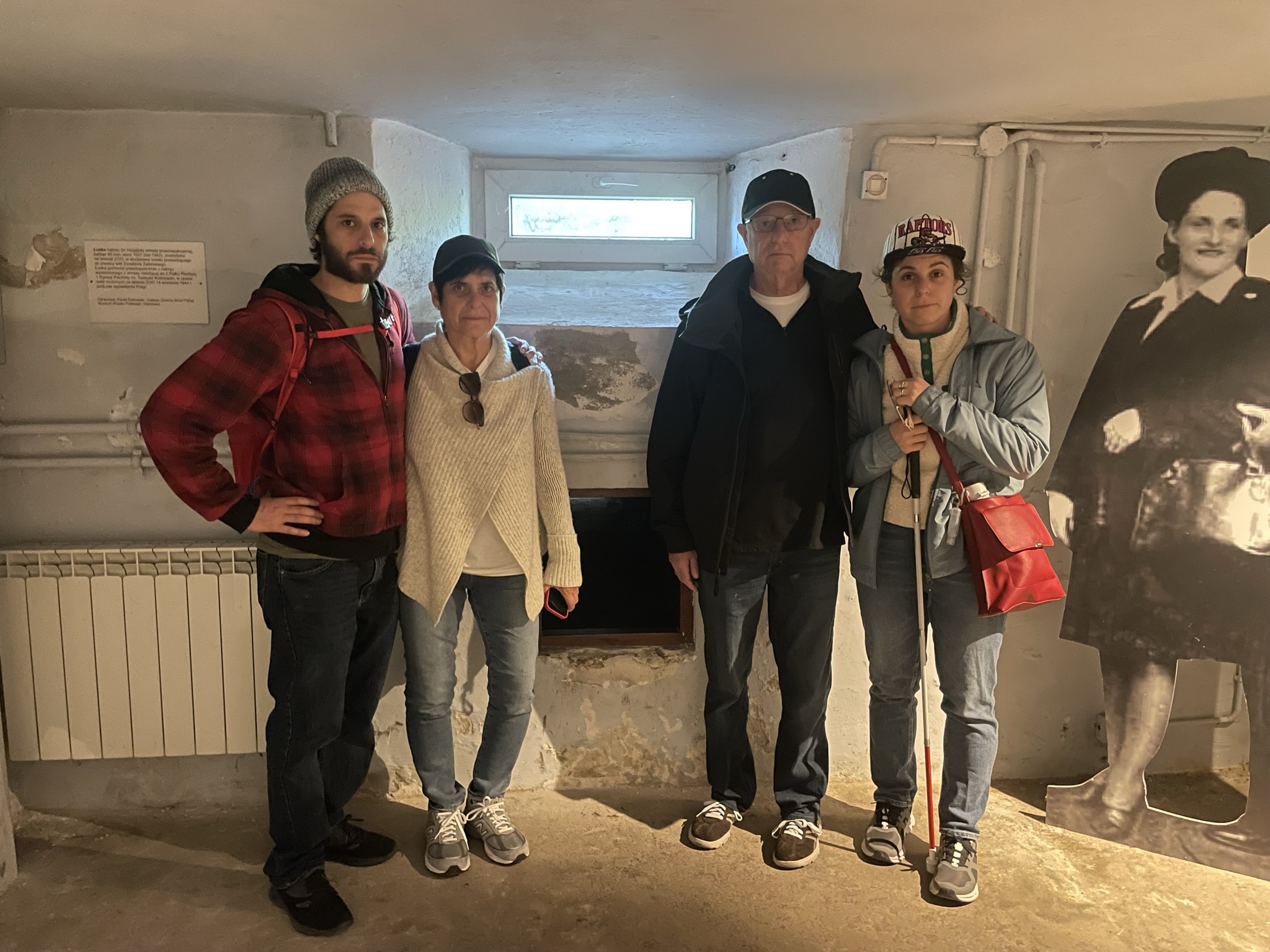 Rachel Ganz with her family inside a historical building. There is a black and white cutout of a woman next to them.