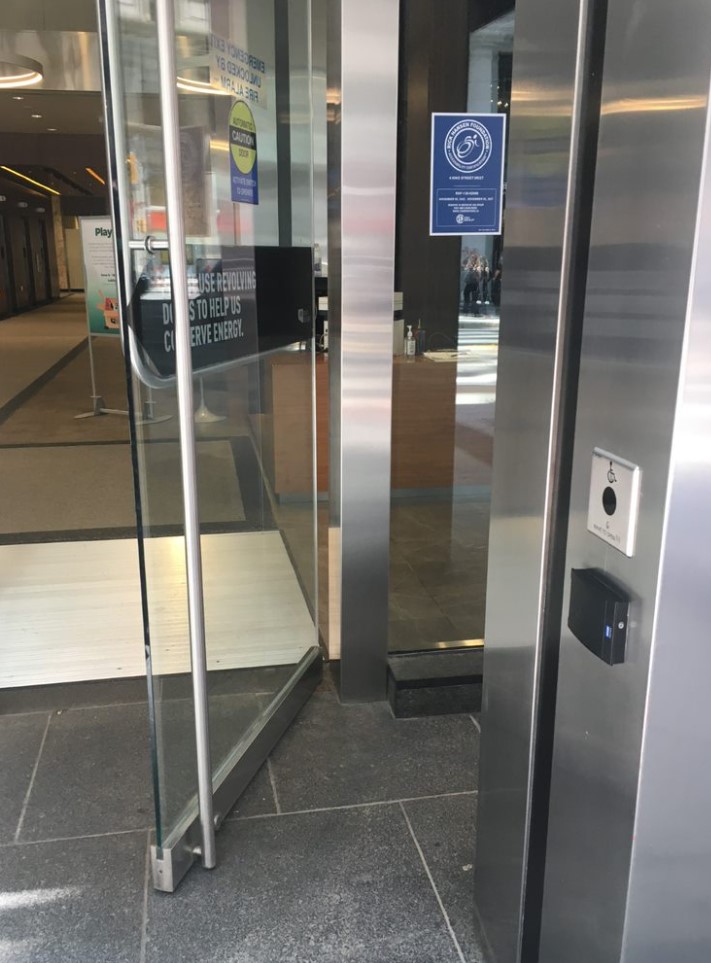 Accessible door in interior of building displaying an RHFAC certification sticker.