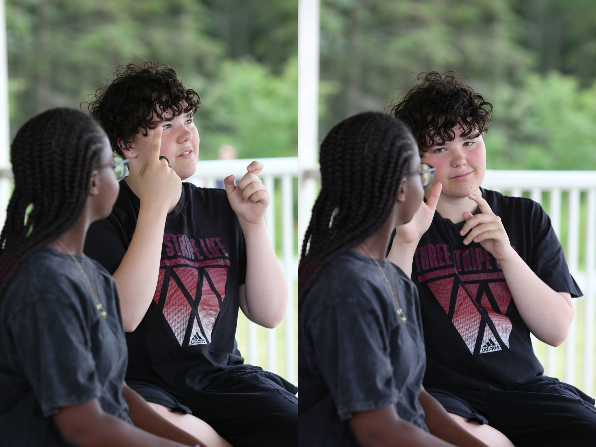 Two people communicating in sign language; one touches his face and points while the other watches attentively
