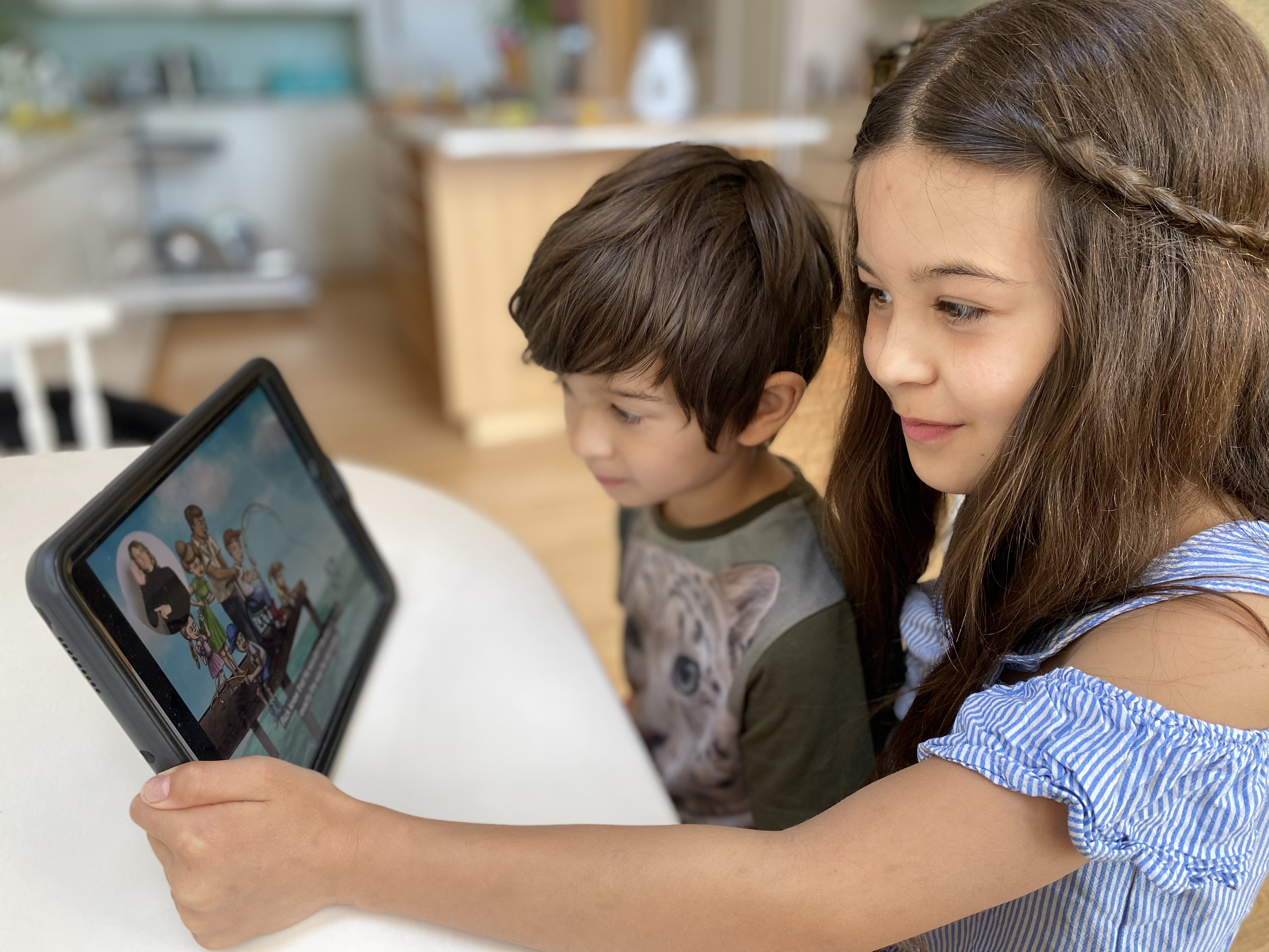 Two kids looking at an ipad