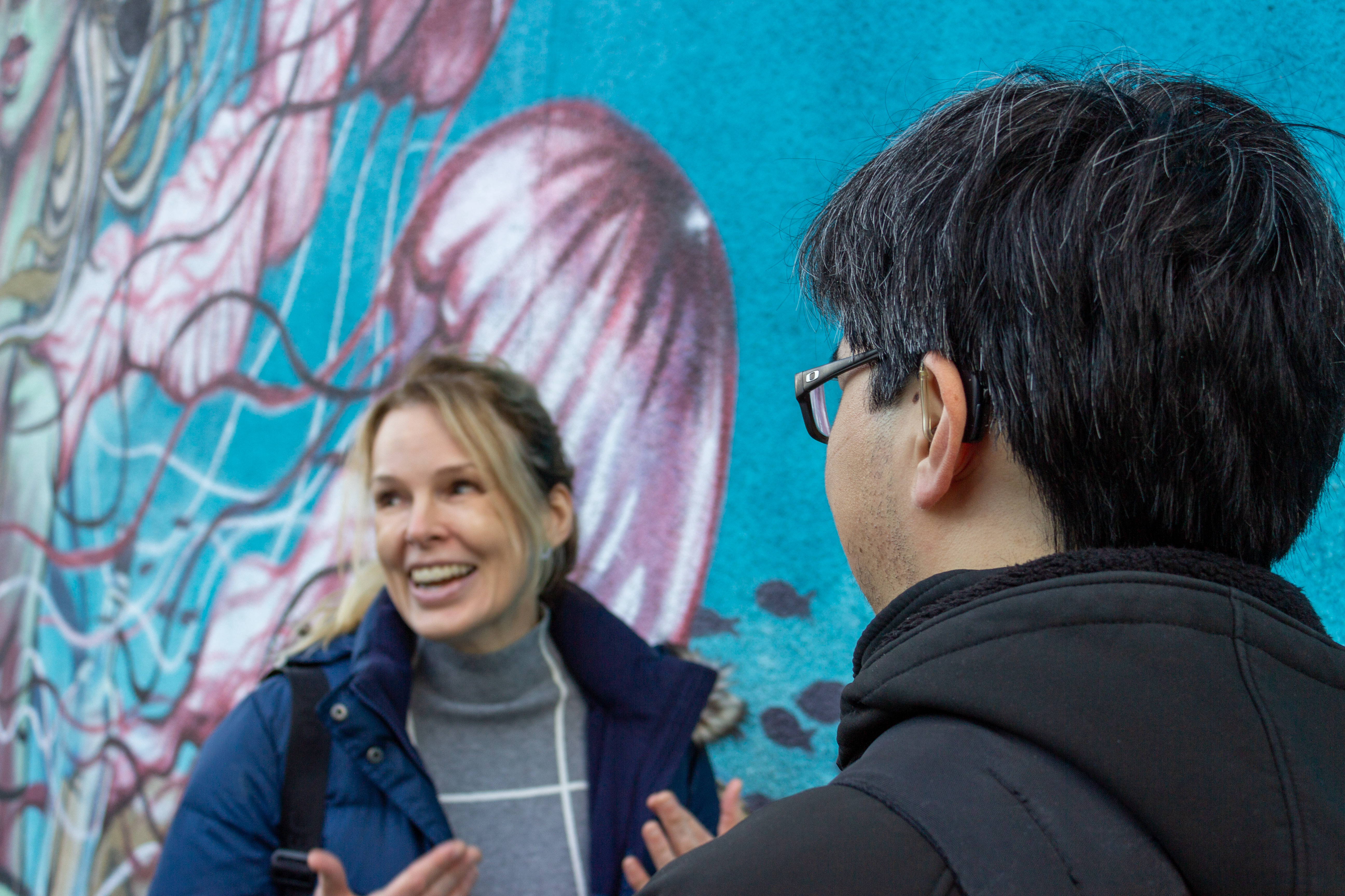 people using hearing aids converse outside