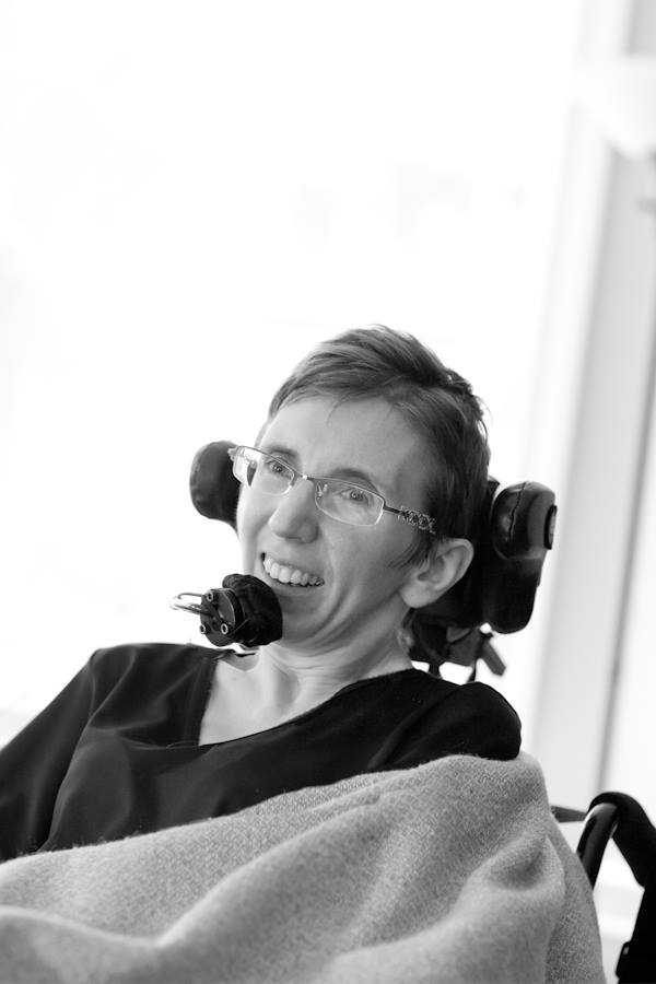 Woman smiling while using in power wheelchair.