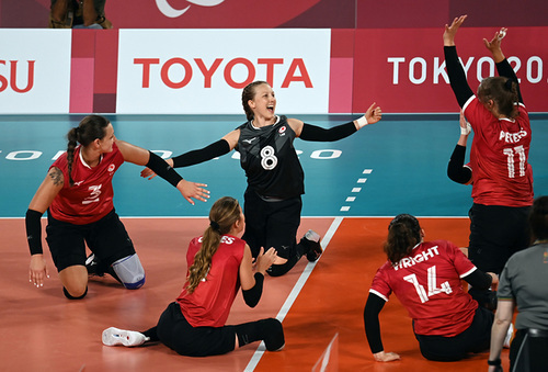 Jolan and her teammates celebrating on the volleyball court. 