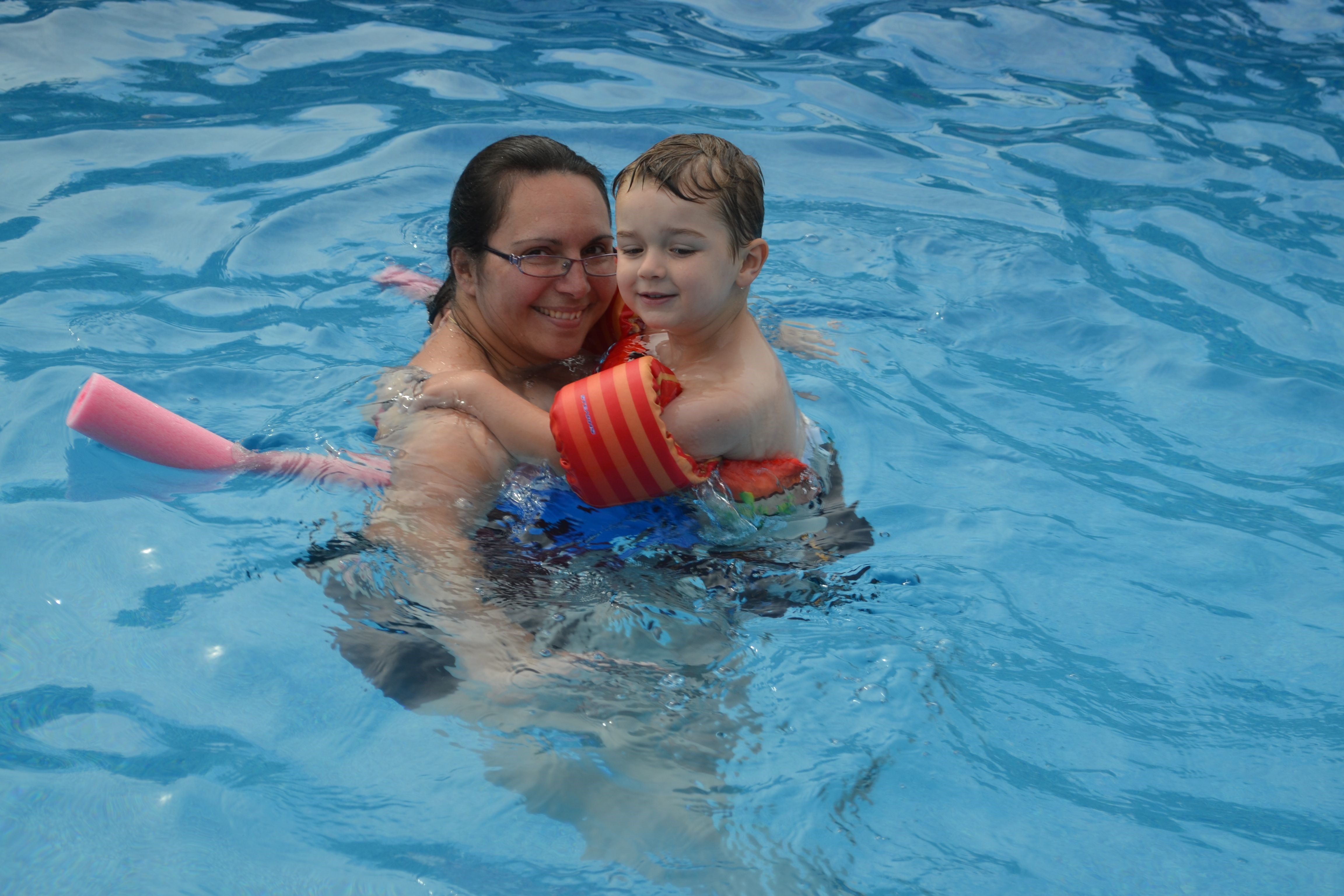 Marjorie and her son Thomas smiling together in a swimming pool.
