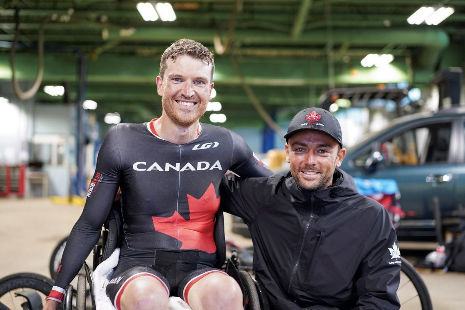 Matt with trainer, wearing team Canada gear, in wheelchair