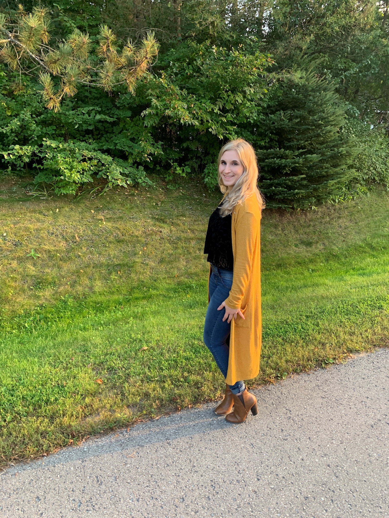 2016 RHFSP Difference Maker of the Year Award winner Maura Del Medico standing on pavement that is next to a field of grass.