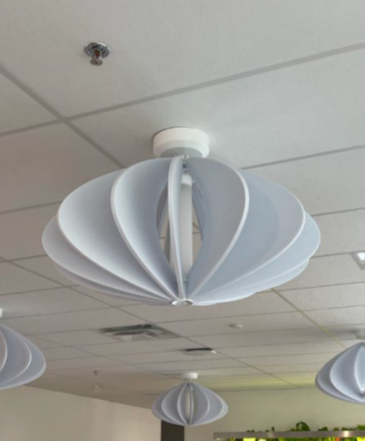 Noise dampening light fixture on acoustic tile ceiling.