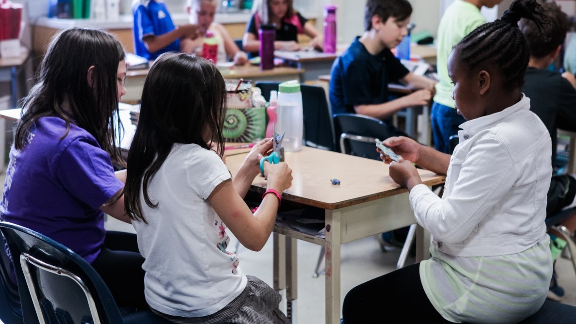 Students work together at a desk