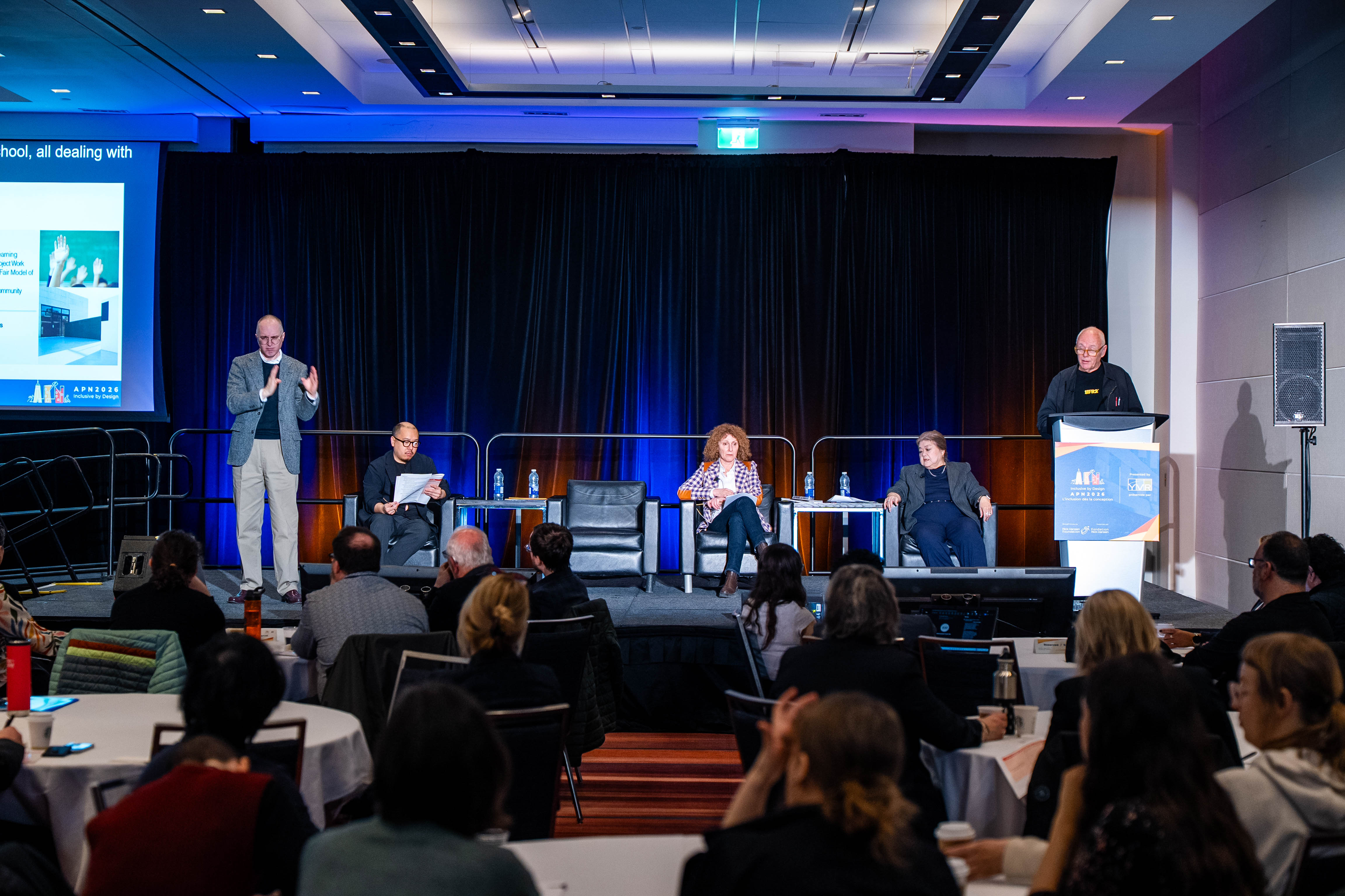 A panel of speakers talk on the stage at APN 2026