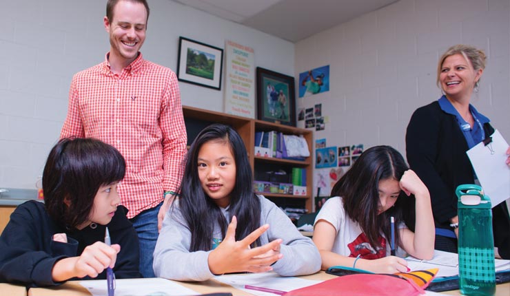 Jonathan and 3 young girls in a school setting. 