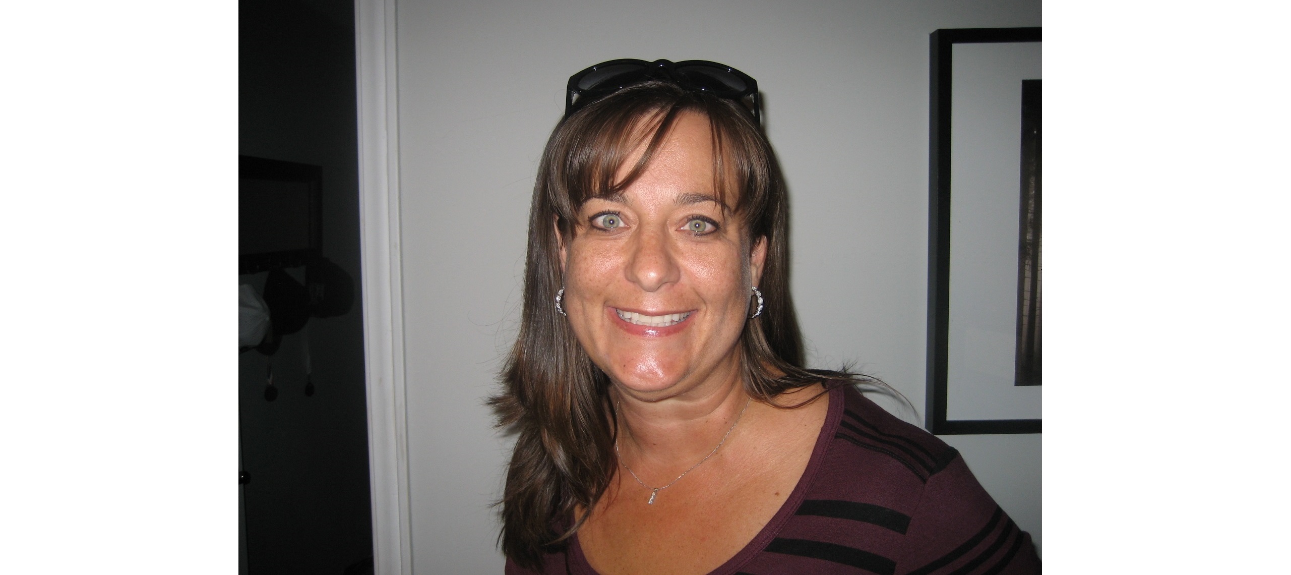 Woman with brown hair smiles with her DM certificate.