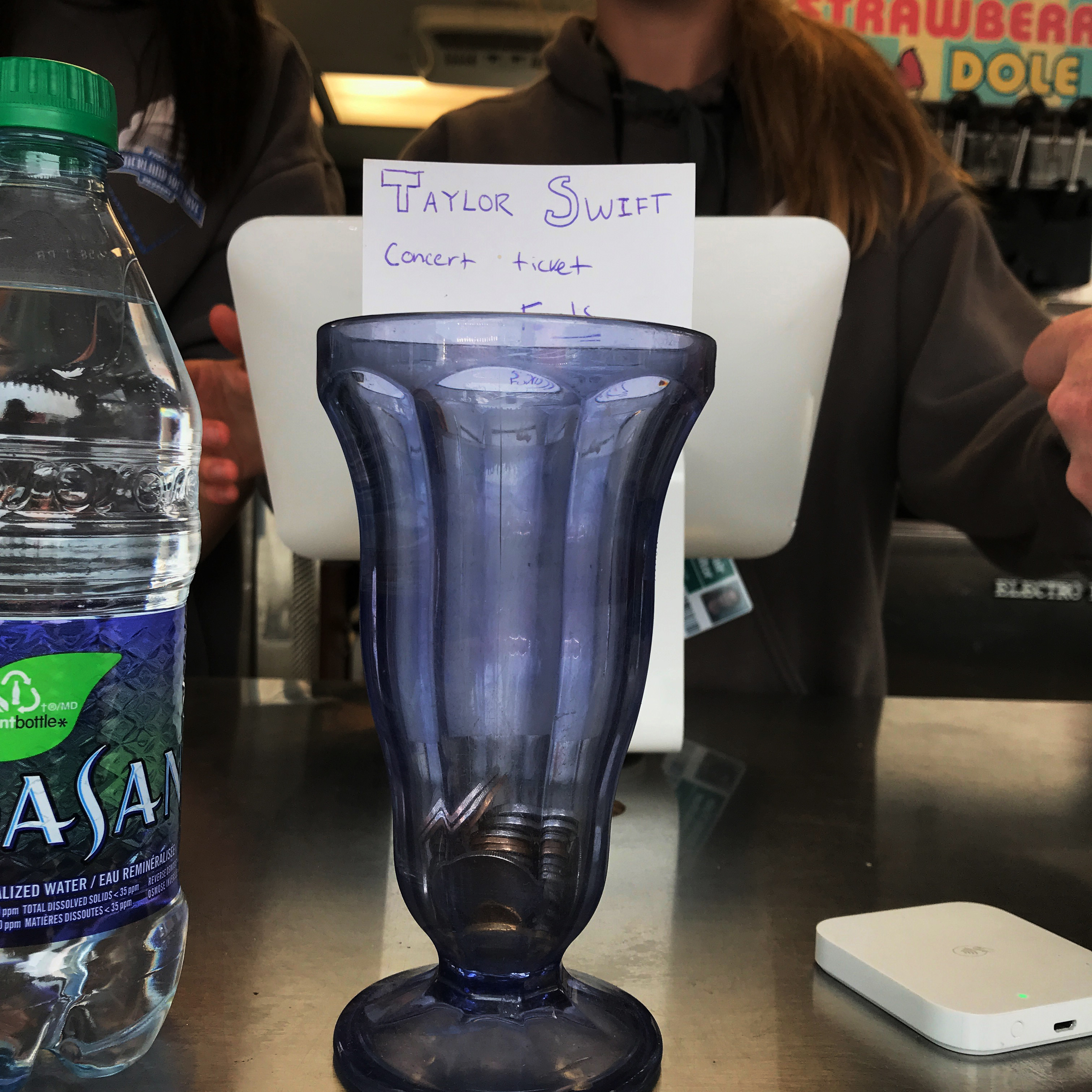 A tip jar at a concession stand for Taylor Swift tickets.