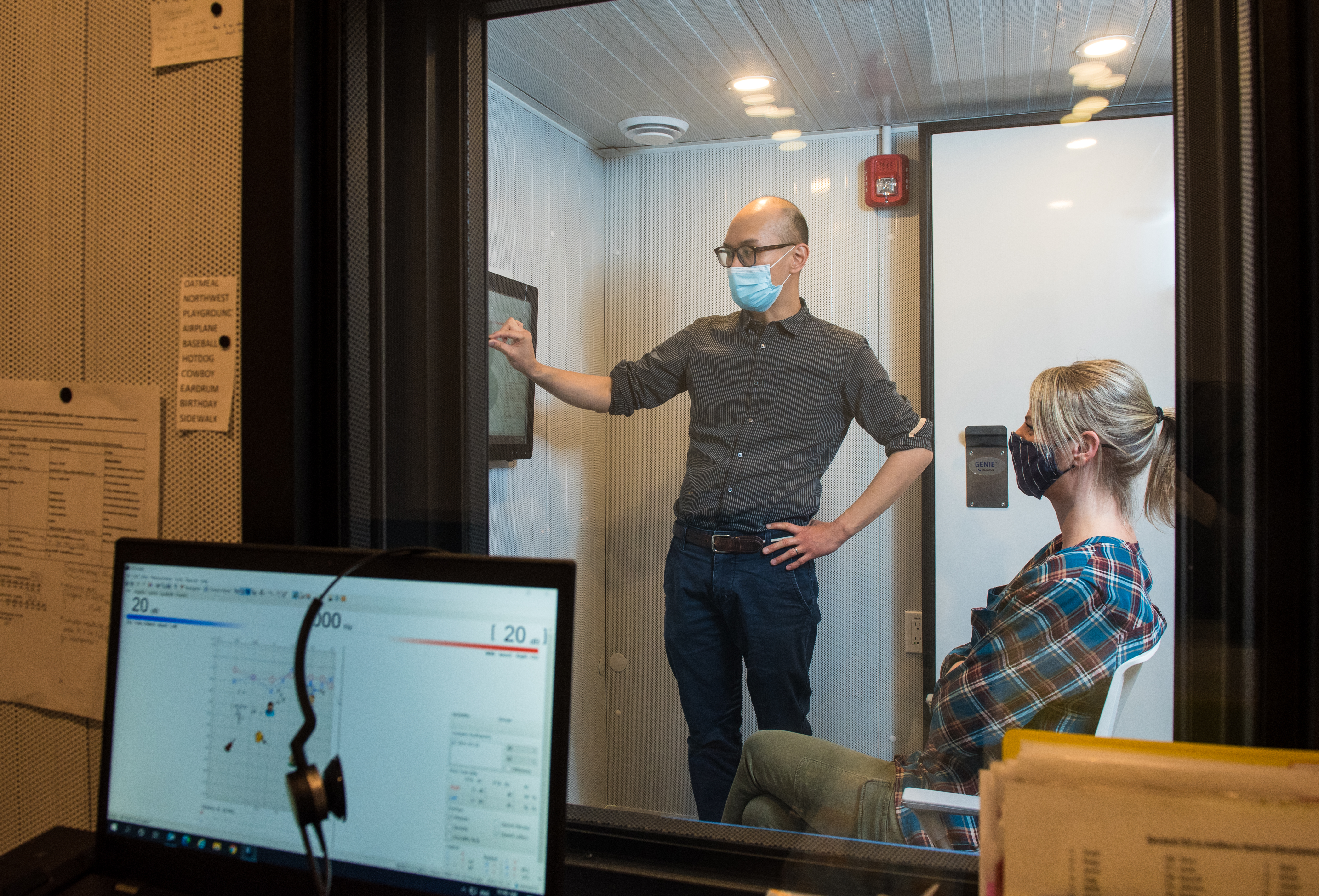 audiologist and patient looking at results