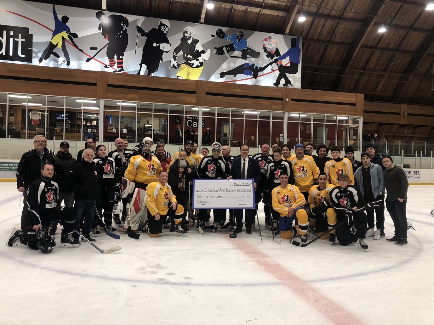 A hockey team posing together on the ice.