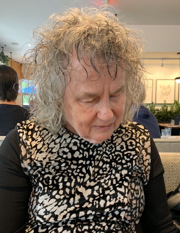 Betty Noble with grey curly hair and a smile