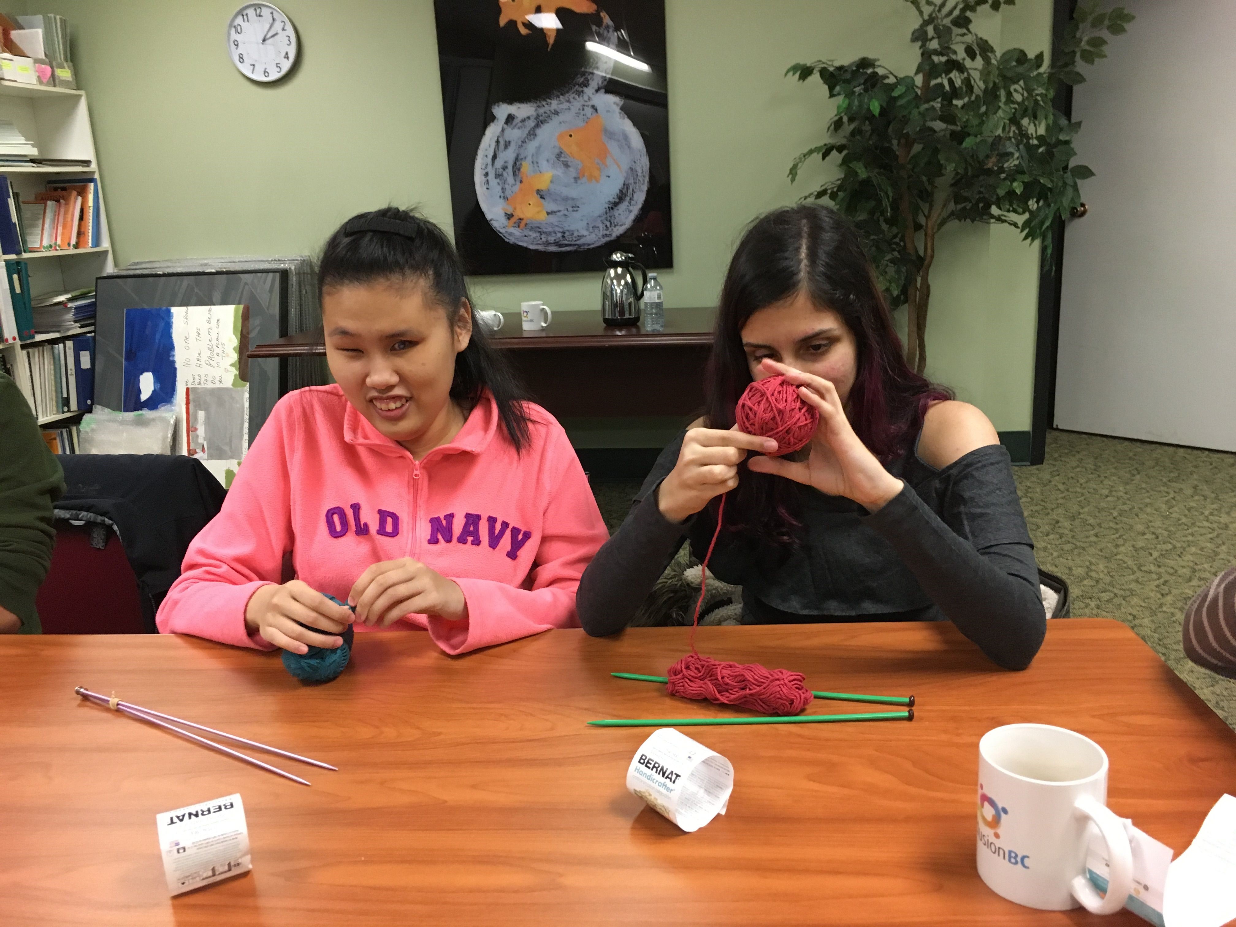 Photo of two visually impaired youth working together on crafting stuffed bunnies.