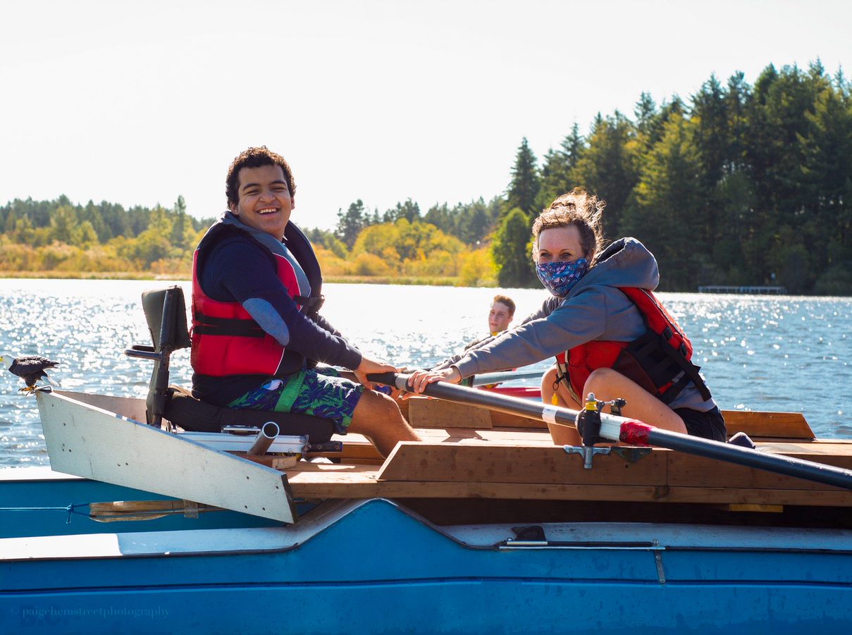 Sebastian and his occupational therapist, Holly, rowing on the lake.
