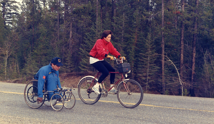 Rick Hansen with Amanda Reid passing through the road. 