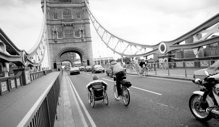 Rick Hansen on tour cycling with his team behind him. 