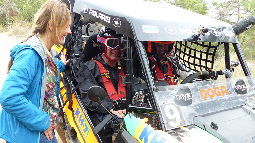 Rick and Isidre in an adaptive motorcross vehicle.