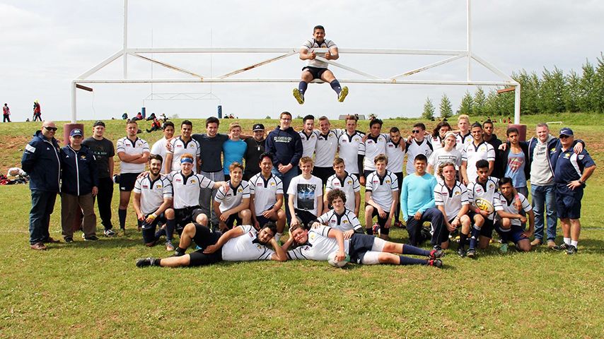 Michael and his friends at a rugby field.