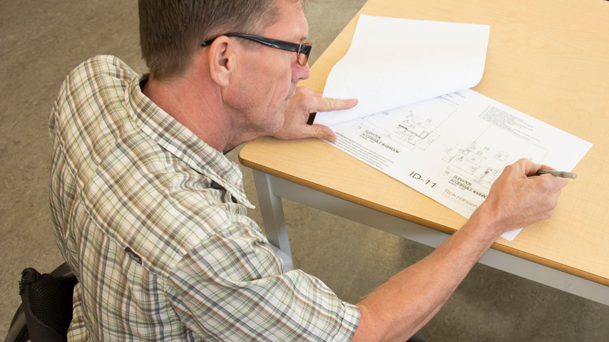 A man writes on a document