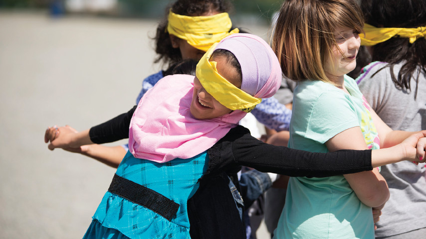Students playing games with blindfolds on.