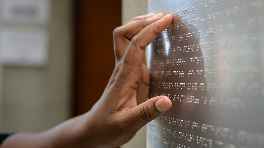 Hand touching on Braille