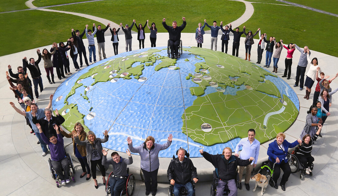 Rick Hansen Foundation staff at Larry Berg Flight Path Park globe