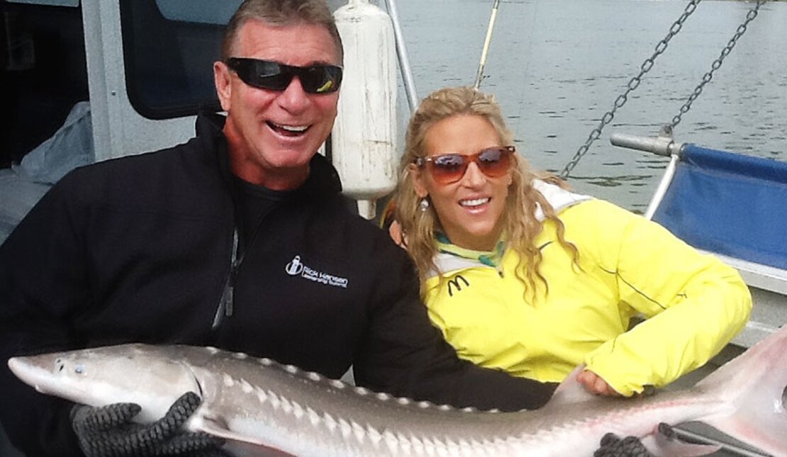 Rick Hansen and Jennifer Gabrysh hold large Sturgeon