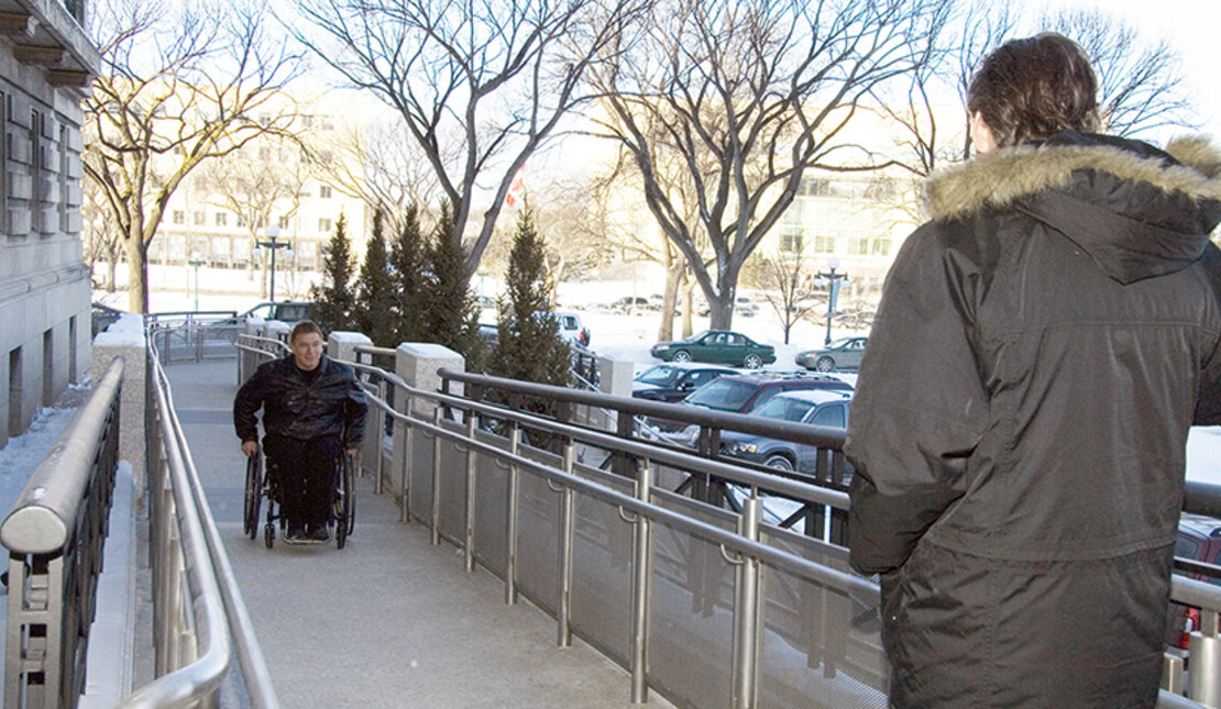 Rick wheels up ramp of Manitoba Legislature