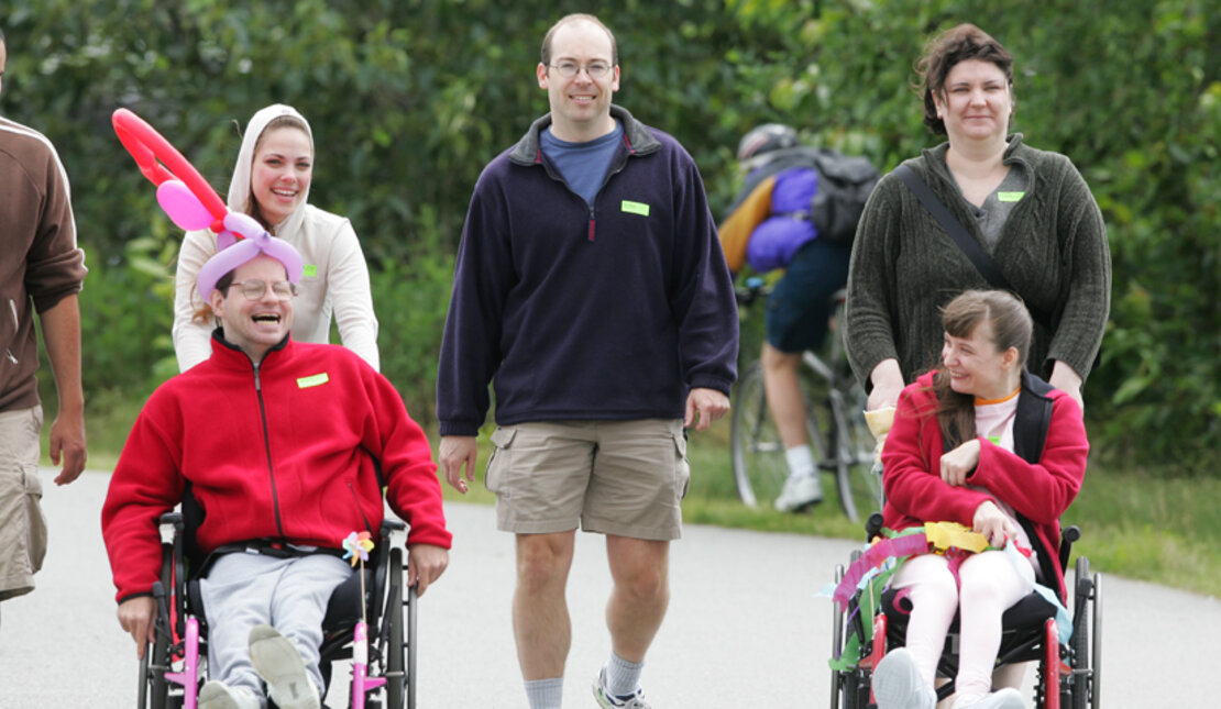 Inclusive group of people with and without disabilities outdoors